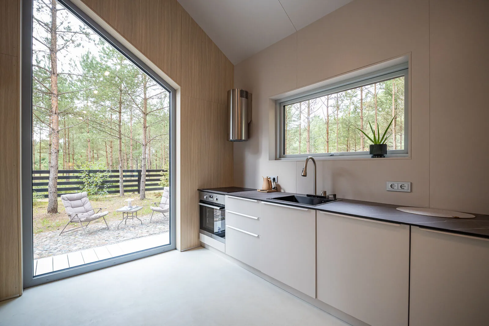 The big-wing kitchen under the tall window